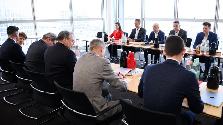 Verhandler der Deutschen Bahn und der Gewerkschaft Deutscher Lokomotivführer (GDL) zu Beginn der Tarifverhandlungen in einem Konferenzraum im Berliner Hauptbahnhof.