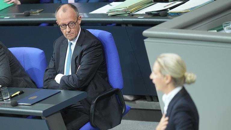 Bundeskanzler Friedrich Merz (CDU) schaut zu Alice Weidel, Fraktions- und Bundesvorsitzende der AfD, während sie in der Generaldebatte im Bundestag zum Haushalt spricht. 