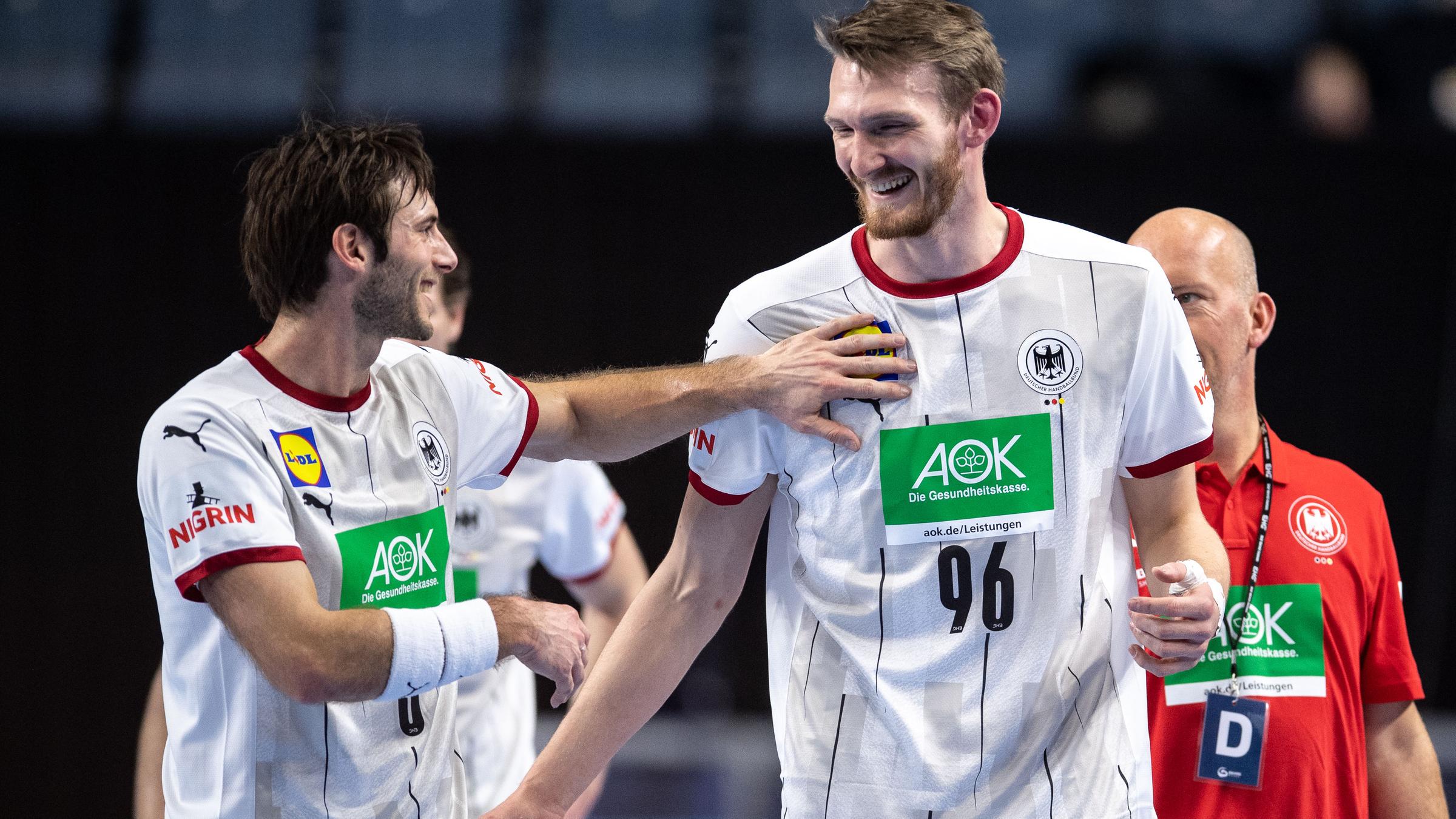 10.01.2021, Handball-EM-Qualifikation, Deutschland - Österreich: Deutschlands Uwe Gensheimer (l.) und Antonio Metzner lachen während der Partie.