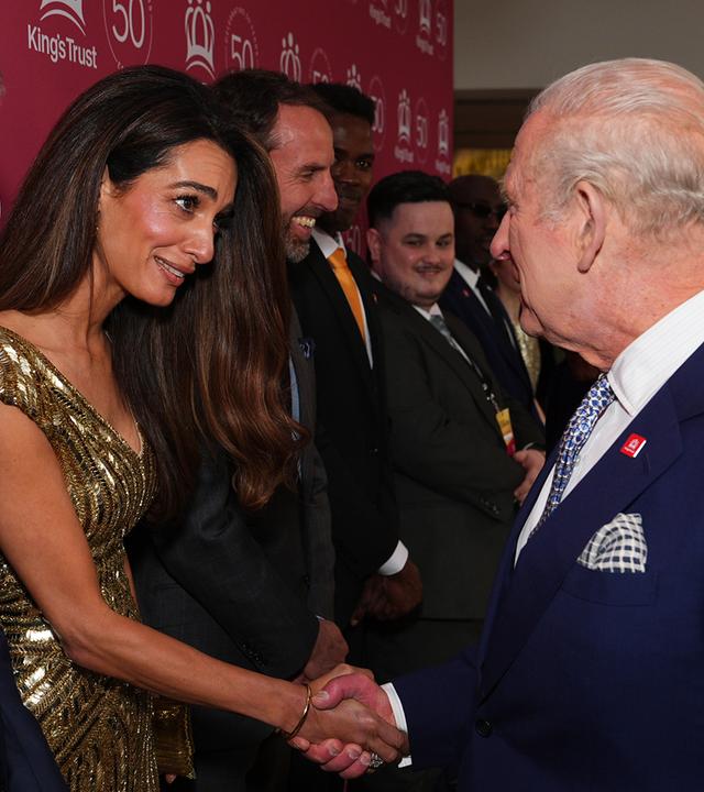 George und Amal Clooney schütteln König Charles die Hand.
