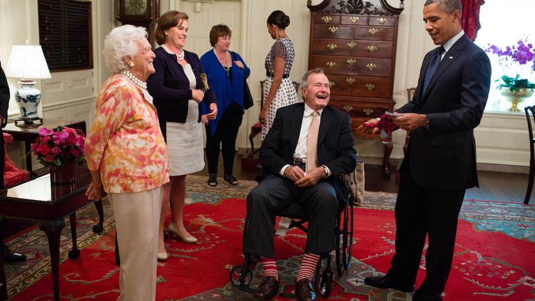 George H.W. Bush und seine Frau schenken Präsident Barak Obama am 5. Juli 2013 ein paar bunte Socken