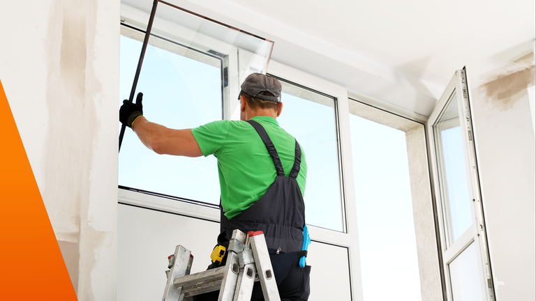 Mann baut neues Fenster in einer Wohnung ein 