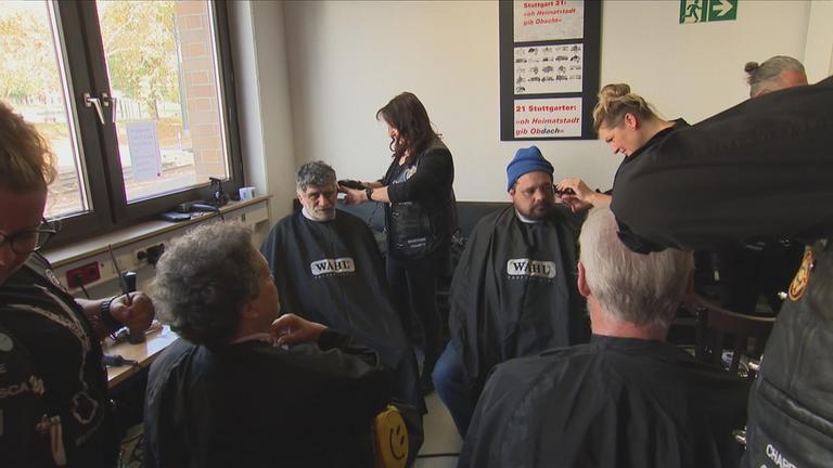 Obdachlosen werden die Haare geschnitten