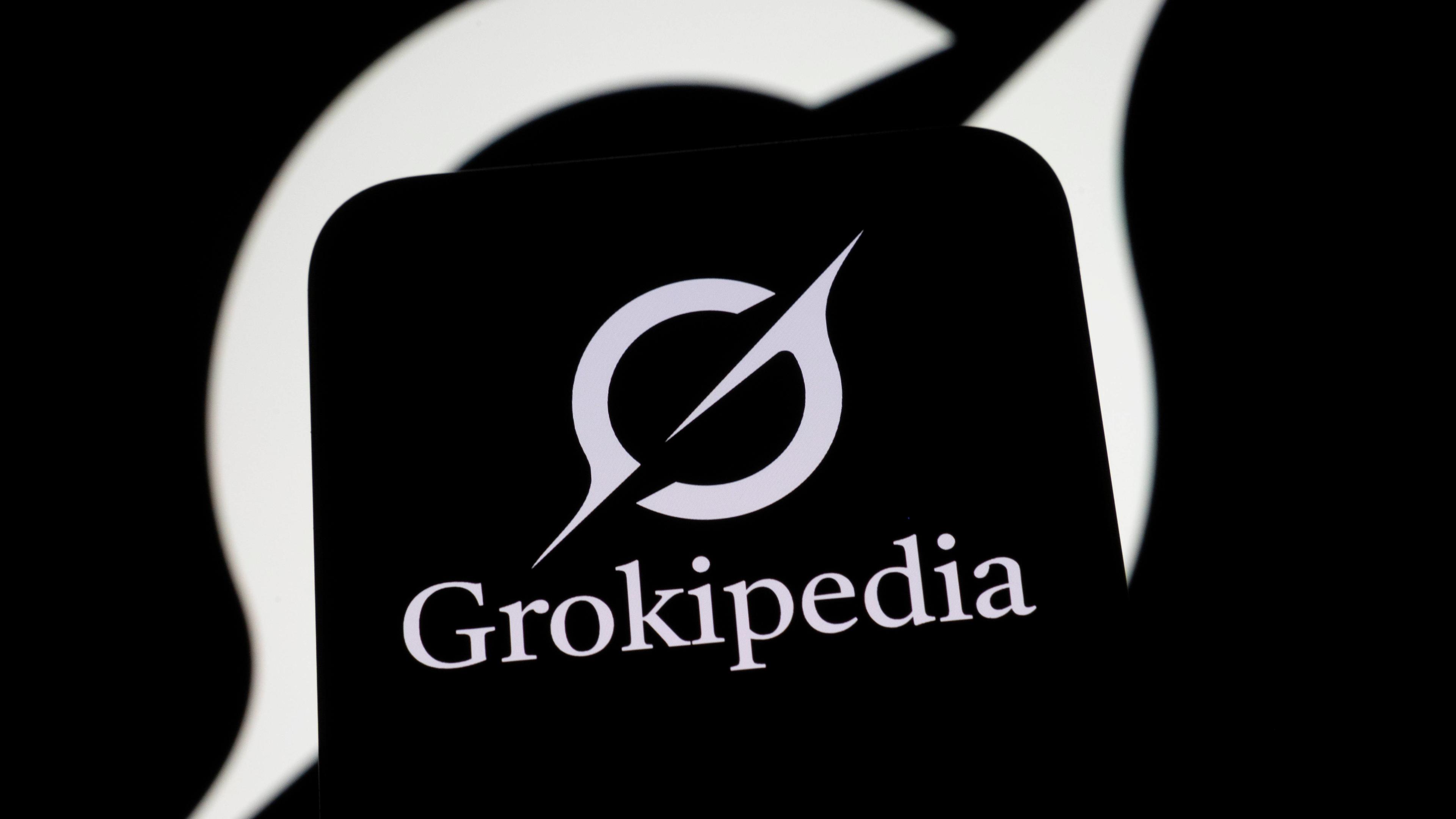 Das Logo der Grokipedia-Enzyklopädie erscheint auf einem Smartphone-Bildschirm mit einem Grok-Logo im Hintergrund.