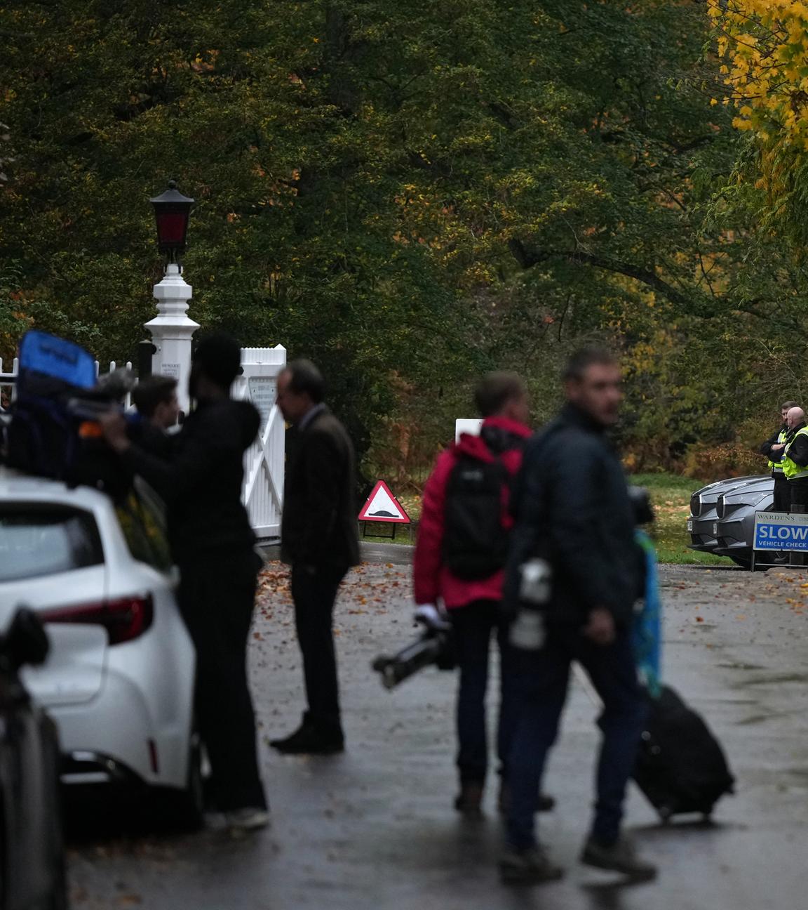 Journalists wait at an entrance near to the Royal Lodge, following the announcement that Prince Andrew will be stripped of his titles and leave the 30-room mansion he has occupied for more than 20 years in Windsor