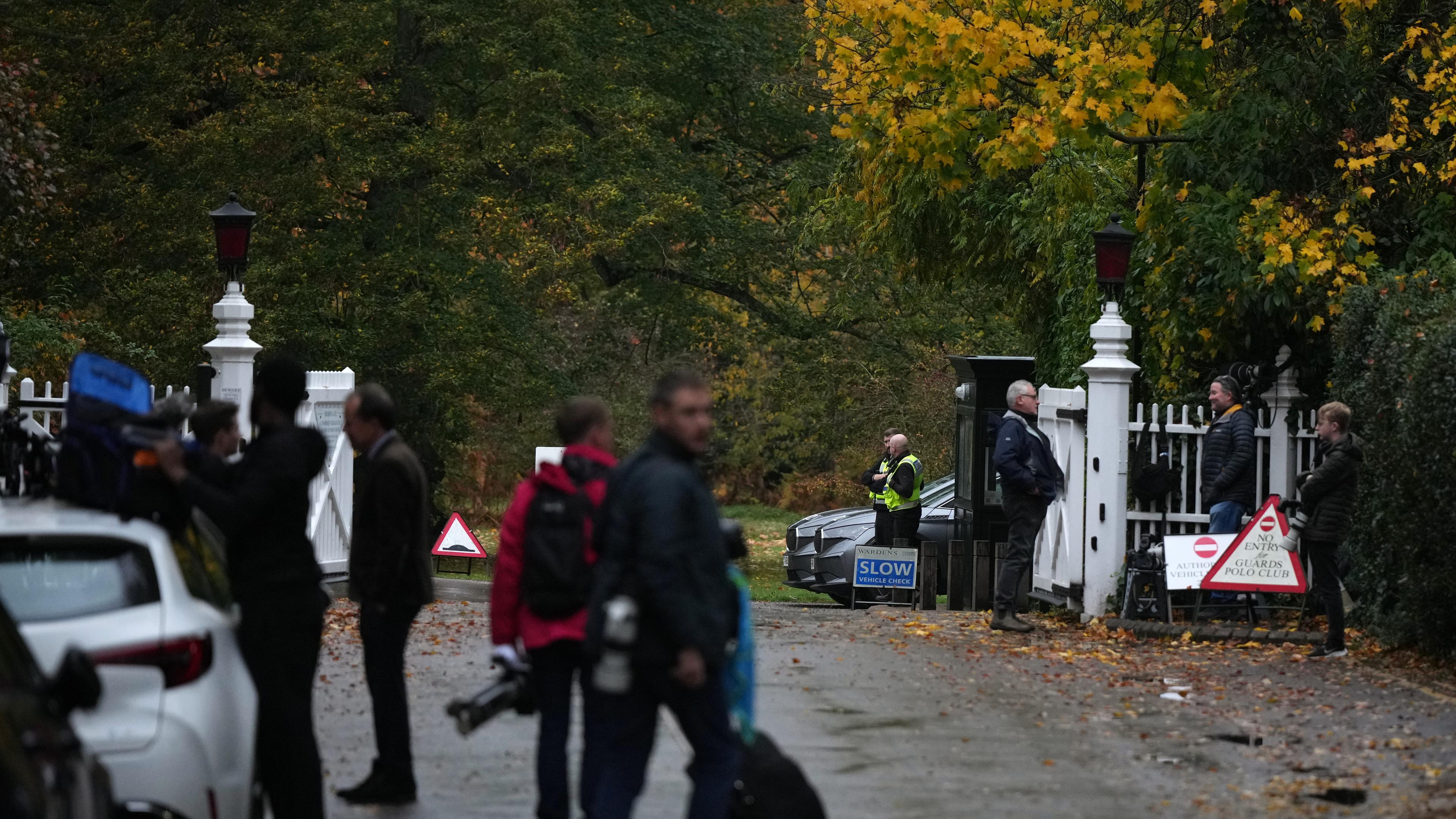Journalists wait at an entrance near to the Royal Lodge, following the announcement that Prince Andrew will be stripped of his titles and leave the 30-room mansion he has occupied for more than 20 years in Windsor