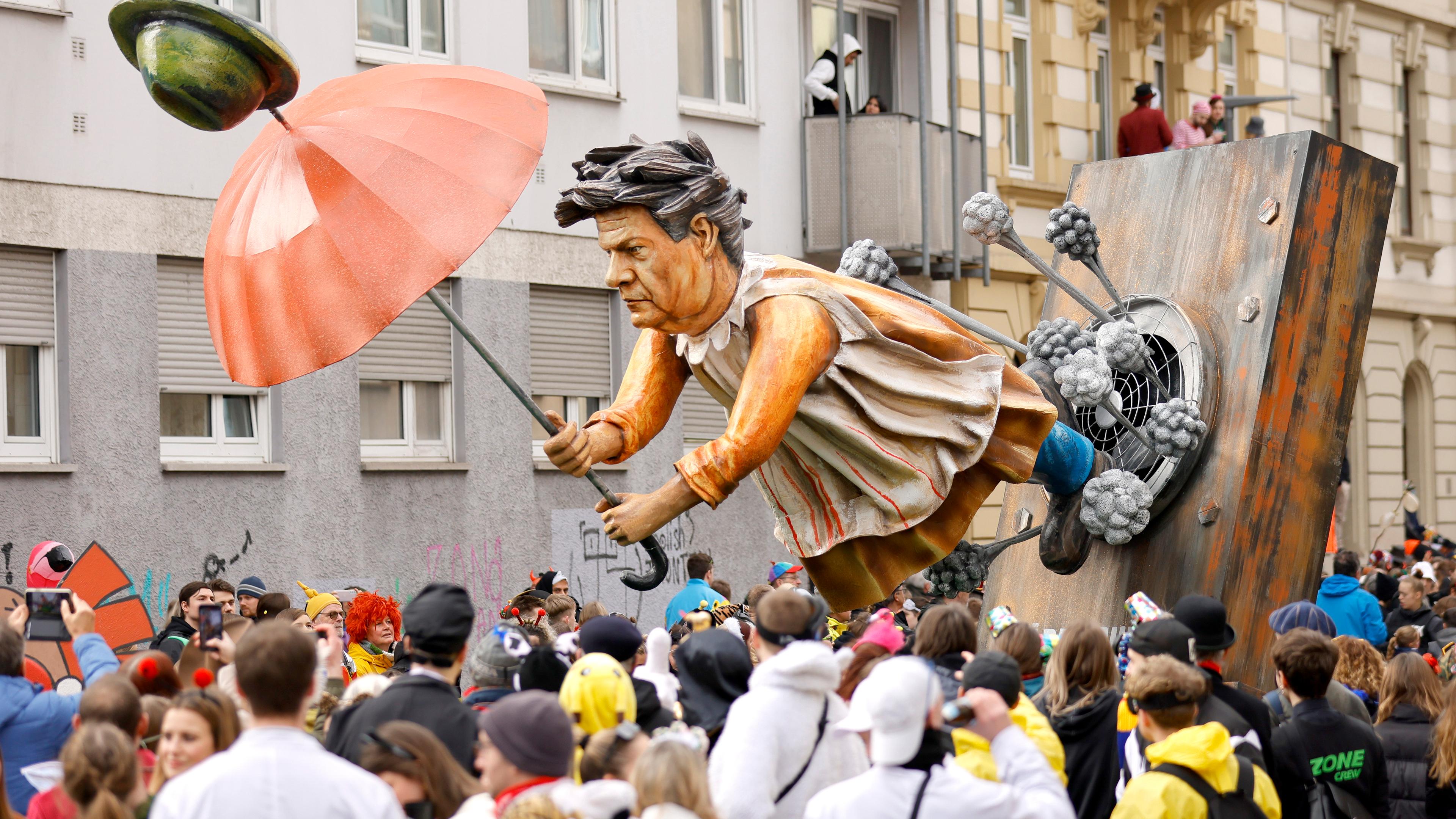 Robert Habeck fliegt mit einem Schirm davon