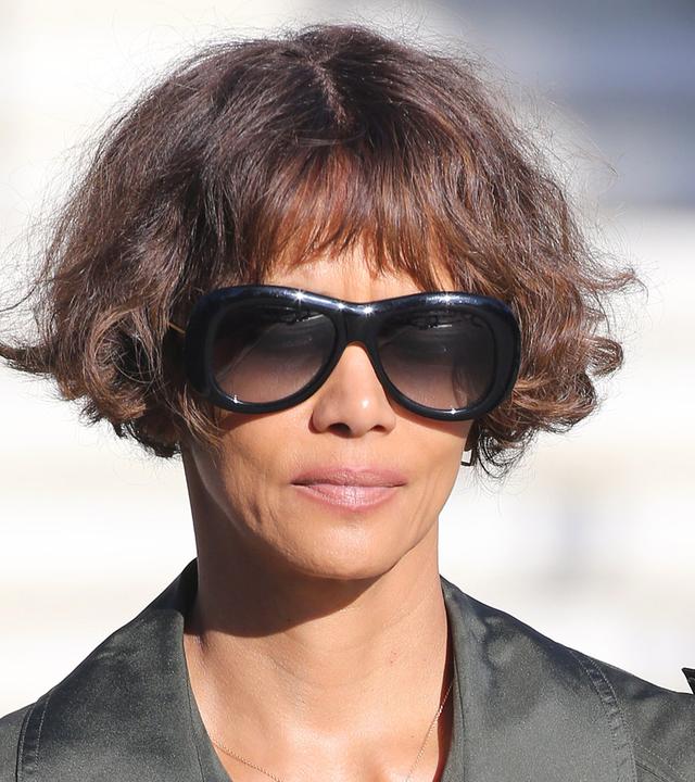 Die amerikanische Schauspielerin und Regisseurin Halle Berry trägt eine große schwarze Sonnenbrille und schaut in die Kamera.