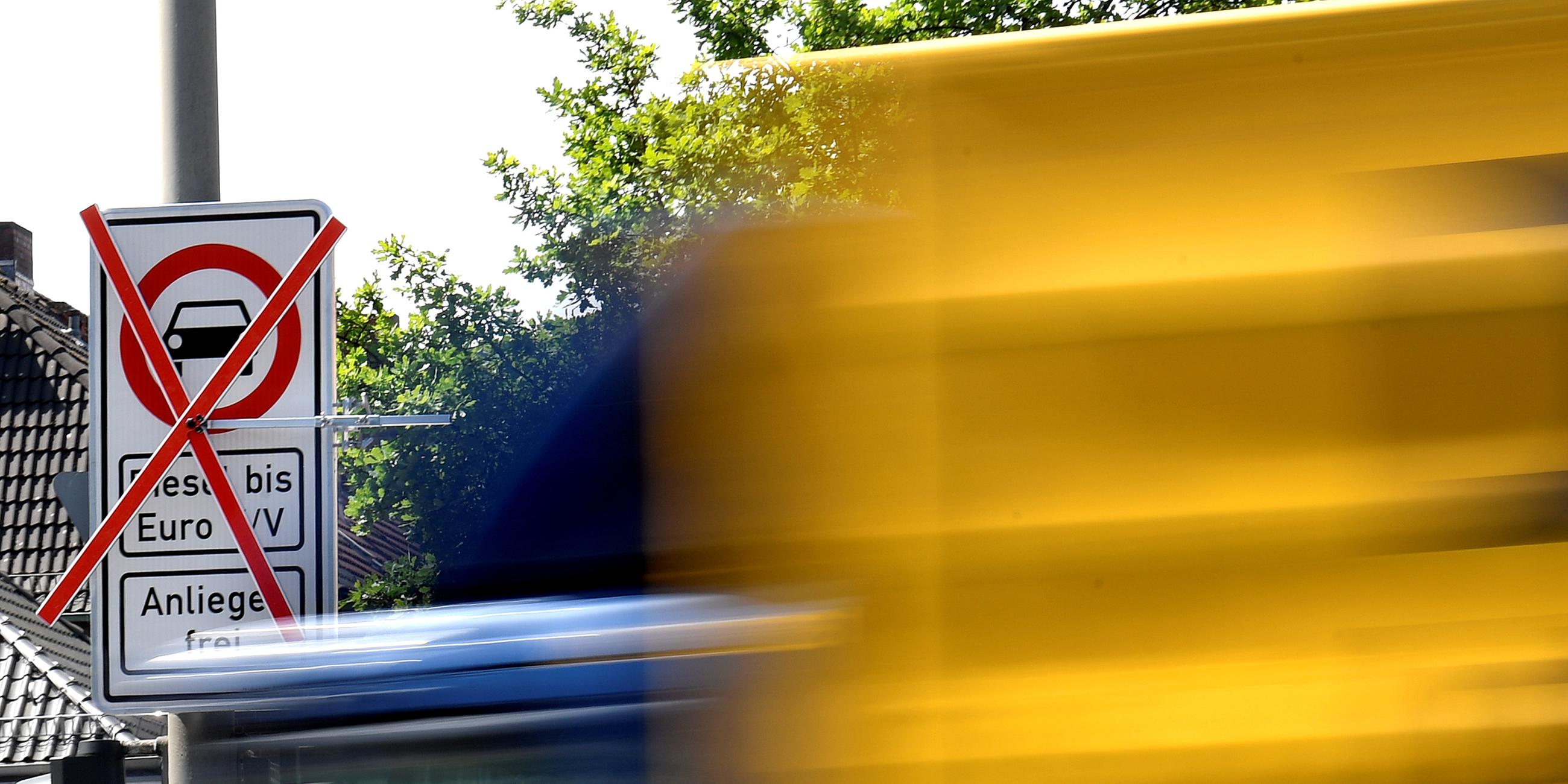 a truck passes a traffic sign showing a ban on diesel cars at the max-brauer allee in downtown hamburg