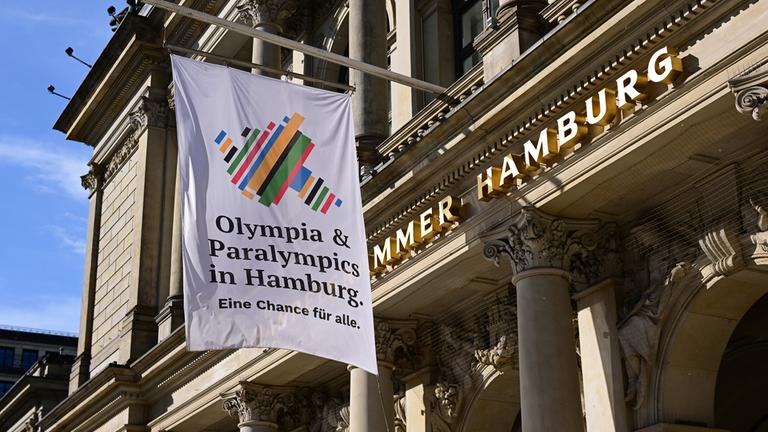 Eine Flagge der Initiative "Olympia und Paralympics in Hamburg" hängt vor der Handeslammer Hamburg