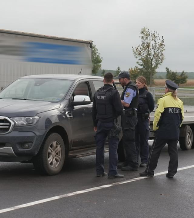 Polizeibeamte kontrollieren einen Autofahrer