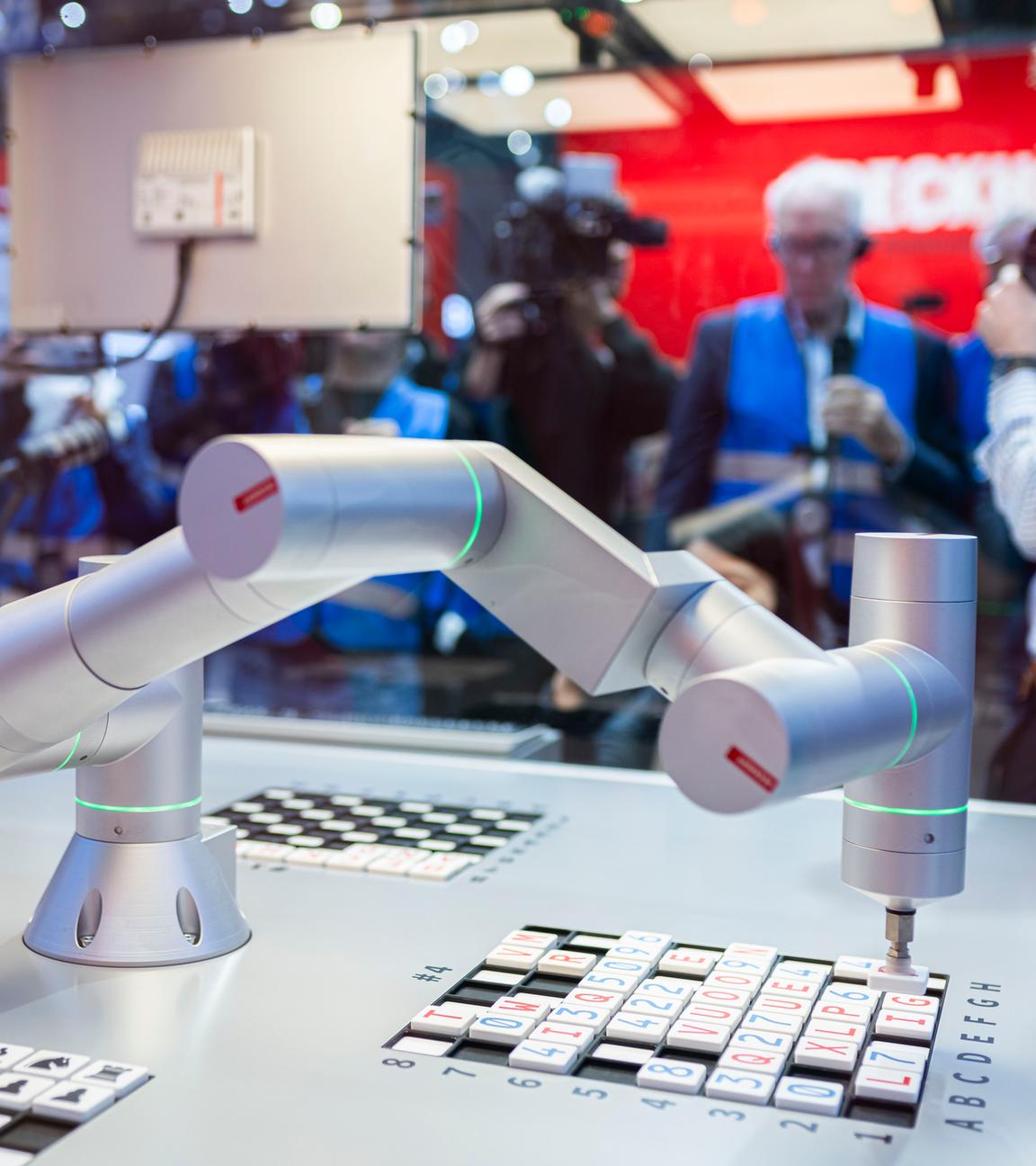 Ein Roboterarm bei einer Demonstration an einem Messestand.