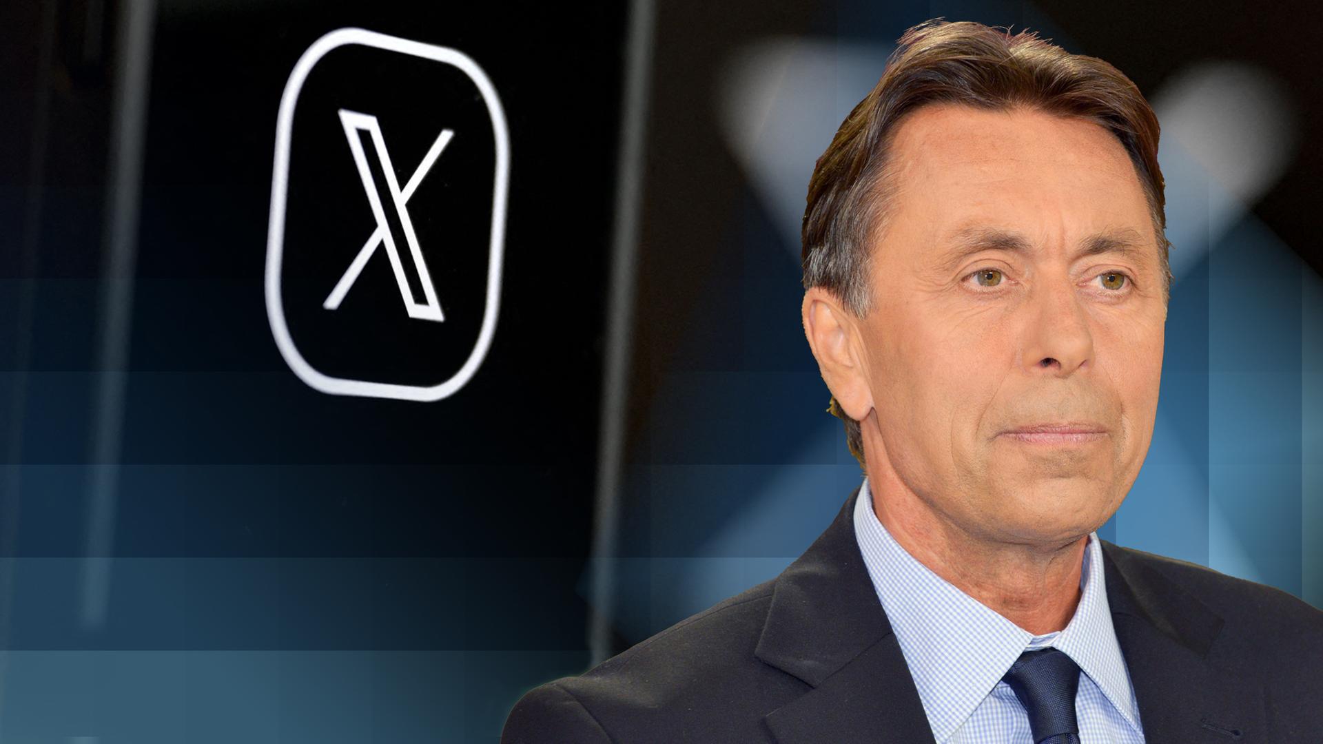 Autor Norbert Bolz steht vor dem "X"- Logo