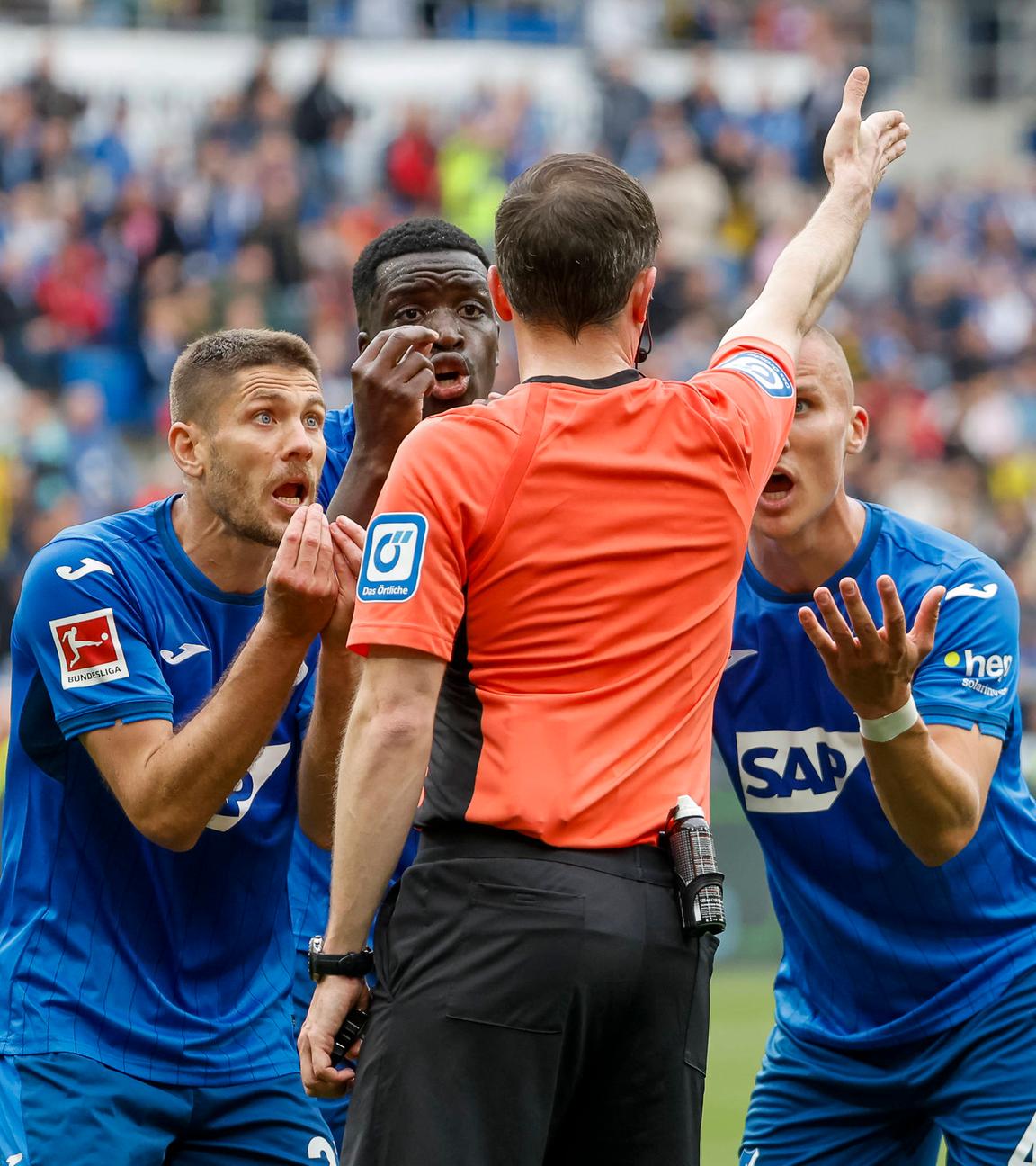 Hoffenheims Spieler diskutieren mit Schiedsrichter Benjamin Brand beim Spiel gegen Dortmund.