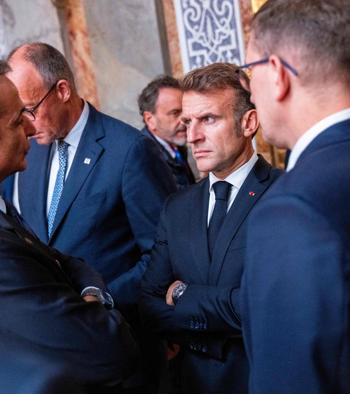 Greece's Prime Minister Kyriakos Mitsotakis (L) and France's President Emmanuel Macron (2ndR) talk prior to the first session of an Informal Meeting of EU Heads of State and Government.
