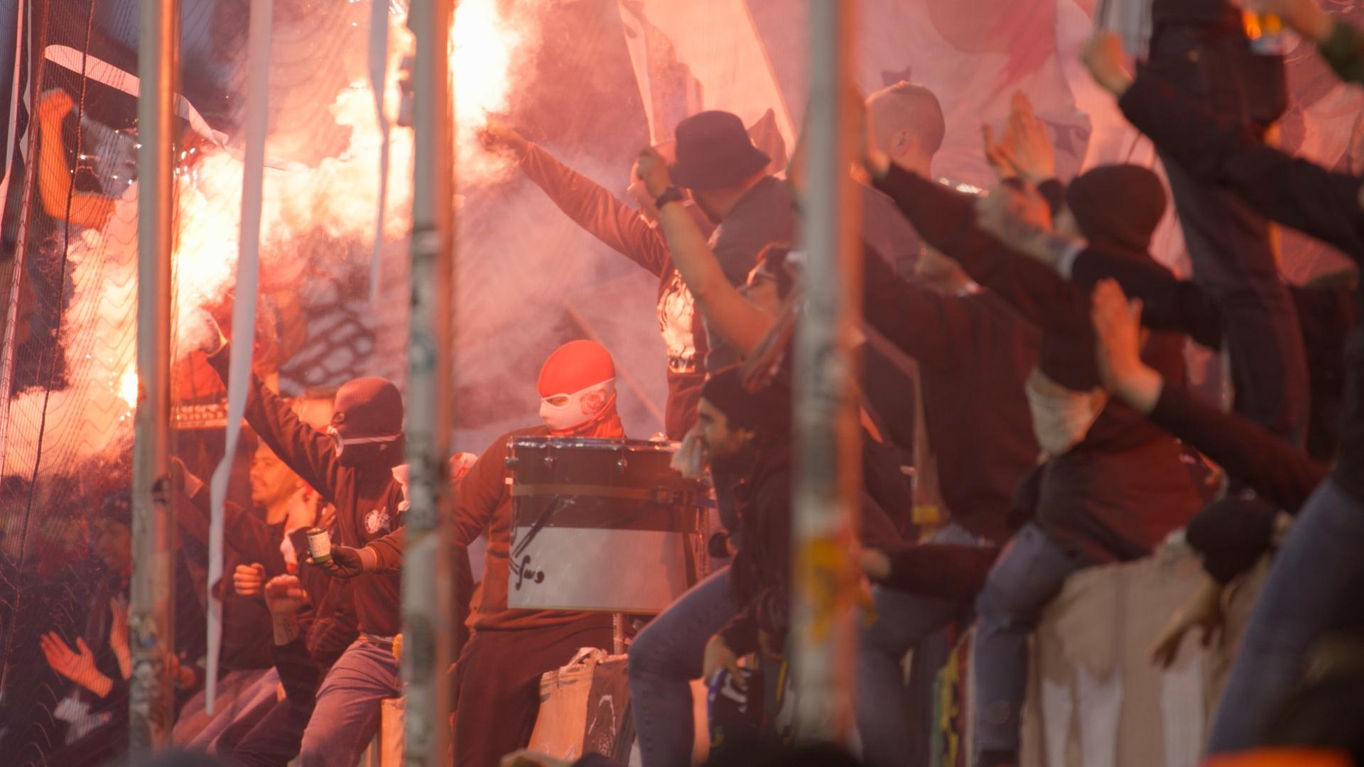 Blick von der Seite auf eine Tribüne: Ultras vom FC St.Pauli zünden Pyrotechnik während des Spiels gegen den FC Hansa Rostock.