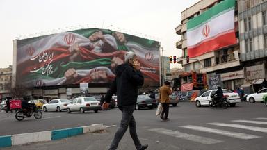 Iranians walk next to a billboard reading 'Iran is our Homeland' at Enqelab Square in Tehran, Iran, 13 January 2026. Iran is experiencing a nationwide internet blackout that began on 08 January 2026, amid an intensifying wave of anti-government protests.