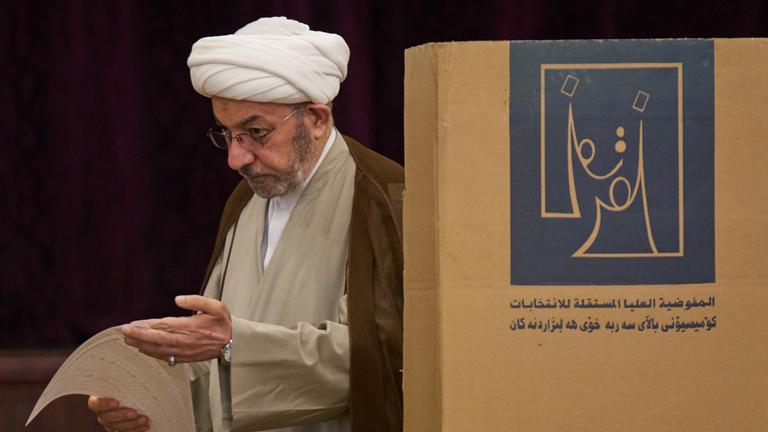 Parlamentswahlen im Irak - Ein Mann gibt seine Stimme in einem Wahllokal bei den Parlamentswahlen ab.