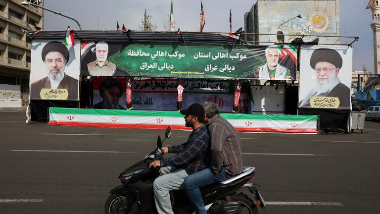 Men drive a motorcycle past billboards of Iranian Supreme Leader Ayatollah Mojtaba Khamenei (L) and his late father, former Iranian Supreme Leader Ayatollah Ali Khamenei (R), in a street in Tehran, Iran, 31 March 2026.