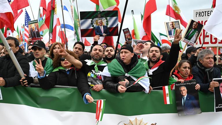 Demonstrierende schwenken Fahnen und rufen Parolen bei einer Kundgebung gegen das harte Vorgehen der iranischen Regierung gegen die eigene Bevölkerung im Iran, am 14. Februar 2026 in München.