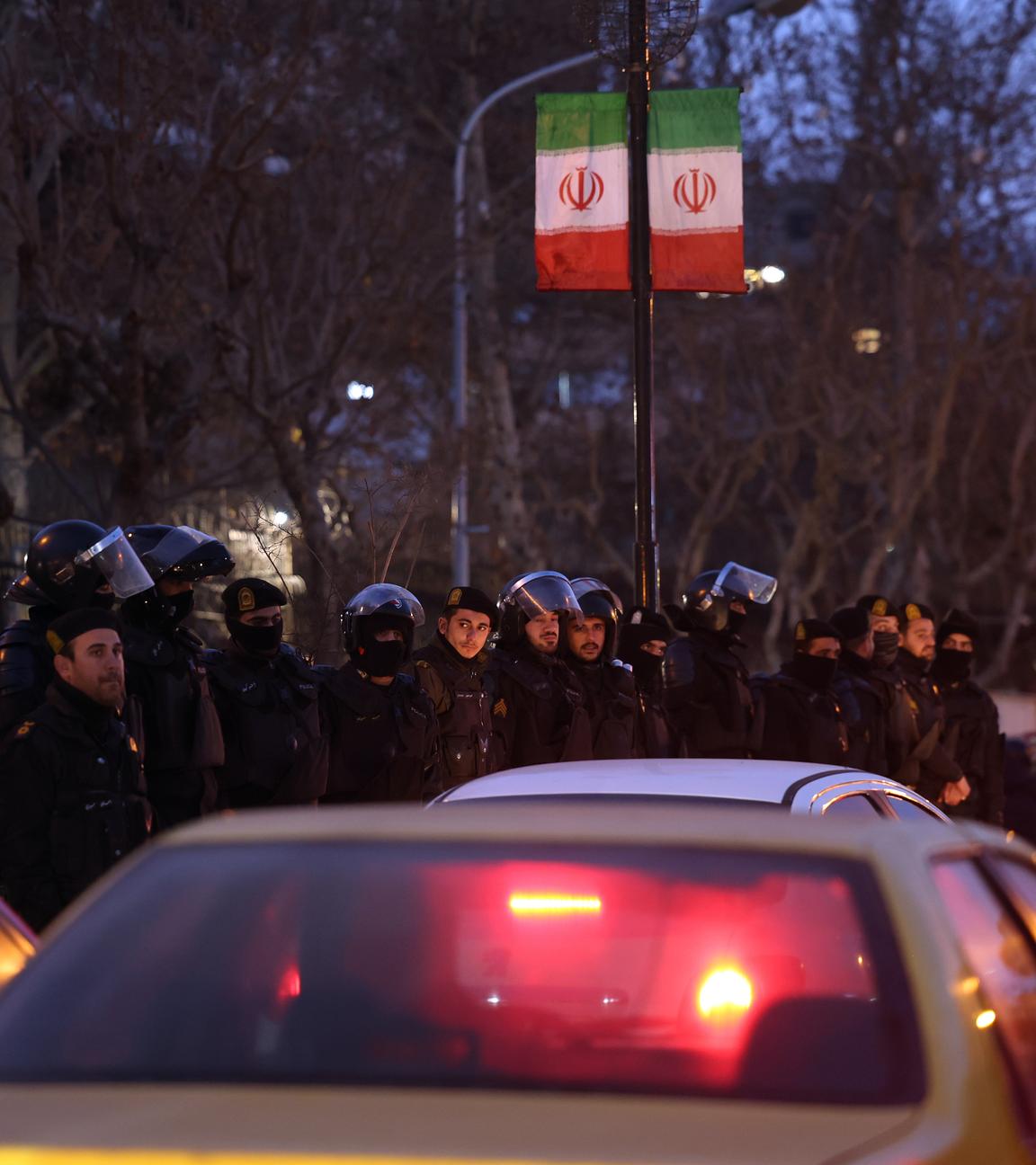Iranische Bereitschaftspolizei steht Wache, während Studenten vor der britischen Botschaft in Teheran protestieren. 