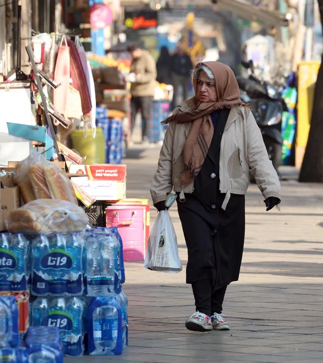 Frau geht im Iran über Marktstraße