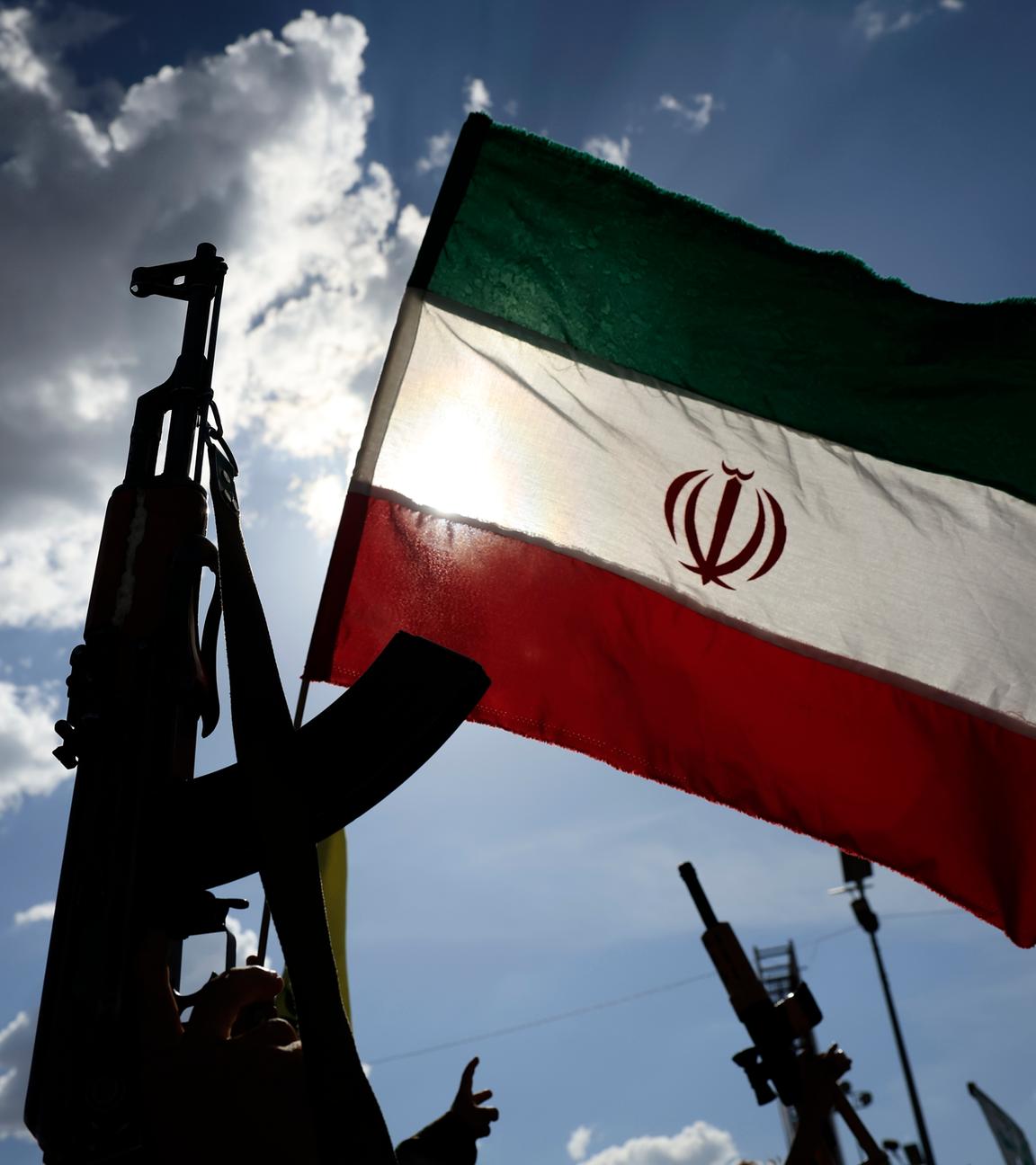 Houthi supporters wave an Iranian flag and brandish a weapon during a solidarity rally with Iran following the US-Iran ceasefire deal, in Sana'a, Yemen, 10 April 2026.