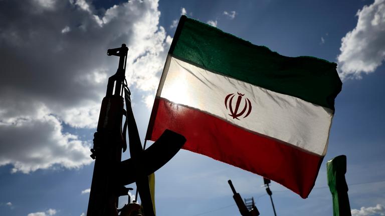 Houthi supporters wave an Iranian flag and brandish a weapon during a solidarity rally with Iran following the US-Iran ceasefire deal, in Sana'a, Yemen, 10 April 2026.