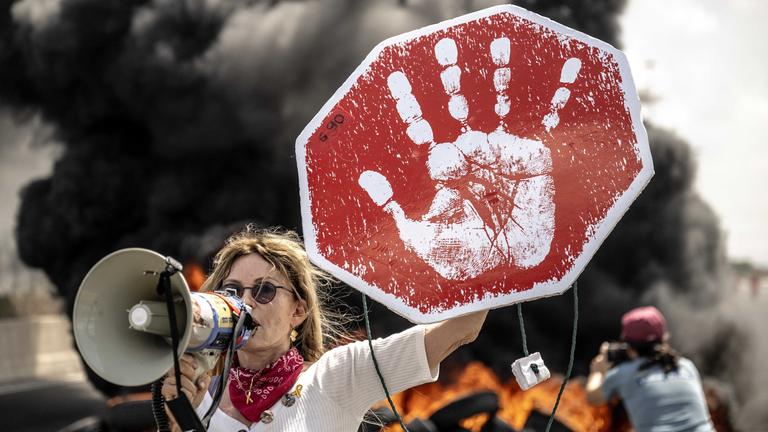  Israeli protesters hold banners and block the road during the demonstration demanding an agreement for the release of Israeli hostages in Gaza.
