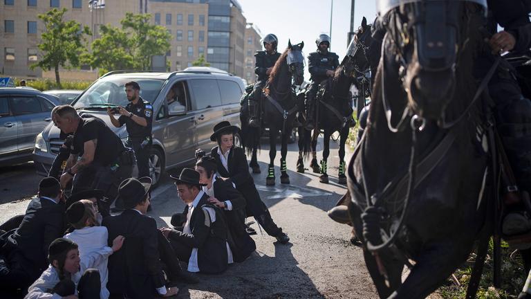 Israelische Polizisten zerstreuen ultraorthodoxe jüdische Männer und Jungen während eines Protests gegen die Rekrutierung durch die Armee in Jerusalem, aufgenommen am 02.06.2024