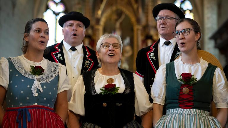 Members of the yodeling club named Jodelclub Stadtjodler Heimelig Frauenfeld perform in a church in Lommis.