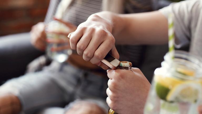 Junger Mann öffnet eine Bierflasche