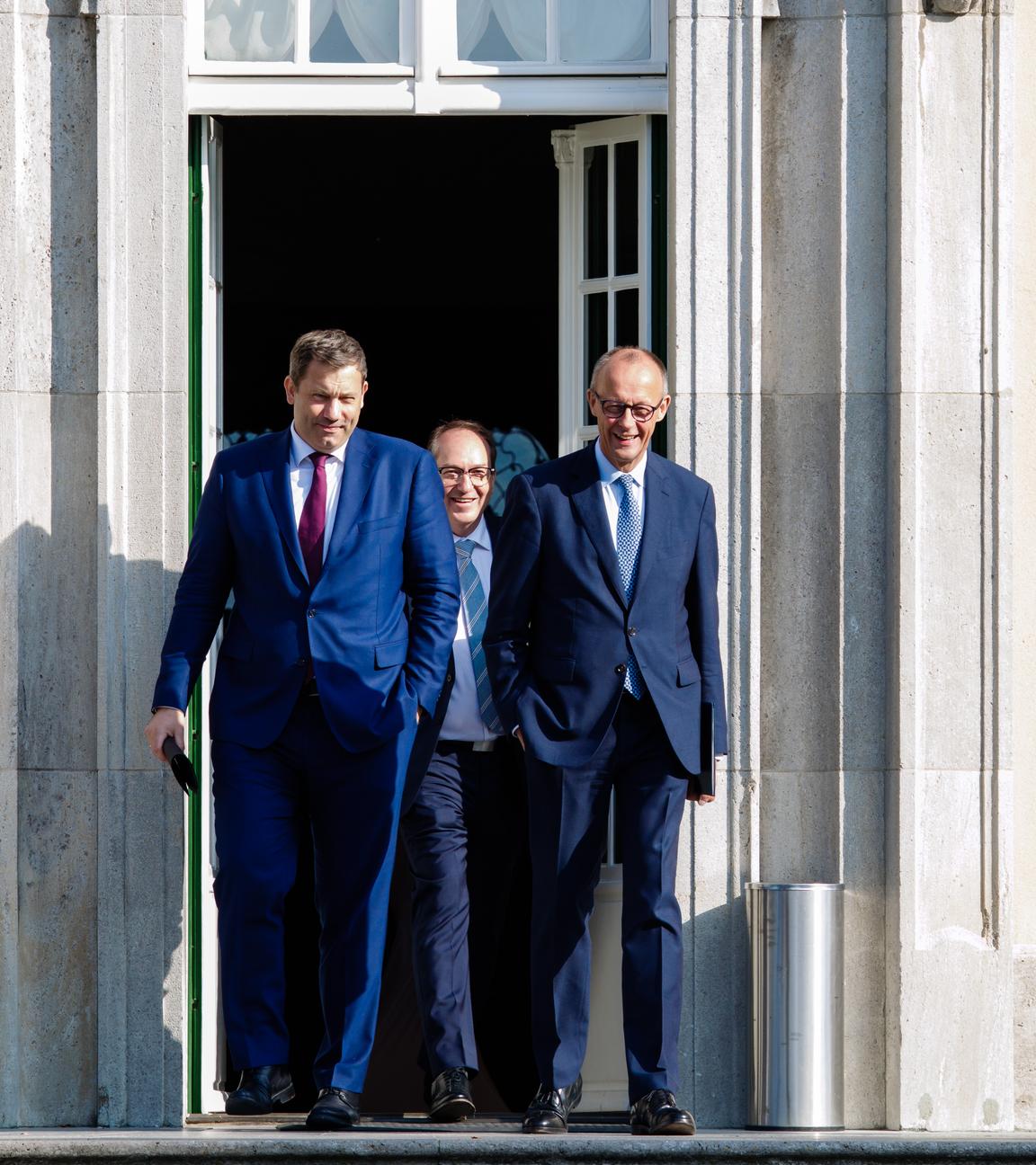 German Finance Minister Lars Klingbeil, German Chancellor Friedrich Merz and German Interior Minister Alexander Dobrindt arrive for a press conference after a cabinet meeting 