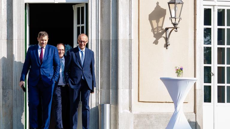German Finance Minister Lars Klingbeil, German Chancellor Friedrich Merz and German Interior Minister Alexander Dobrindt arrive for a press conference after a cabinet meeting 