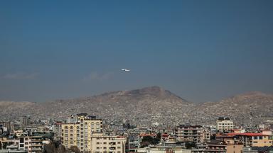 Ein Flugzeug fliegt über Wohn- und Geschäftshäuser, Kabul, Afghanistan.