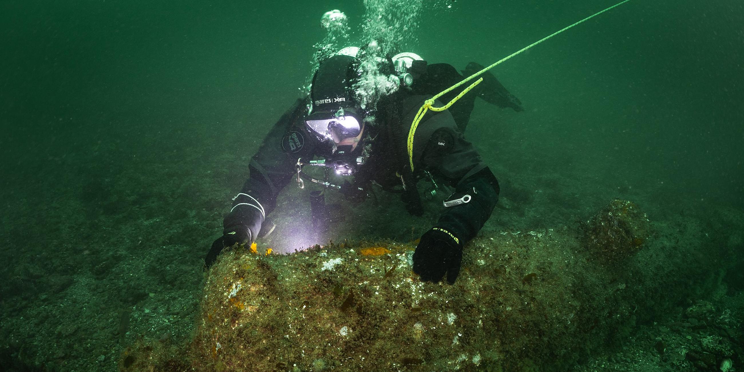 Ein Kieler Forschungstaucher dokumentiert eine der 16 vor Helgoland entdeckten englischen Kanonen.