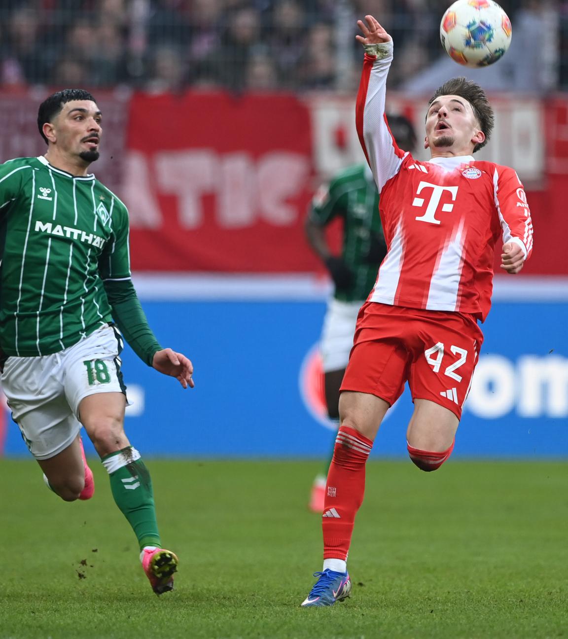 Bayerns offensiver Mittelfeldspieler Lennart Karl versucht im Zweikampf mit Cameron Puertas den Ball zu kontrollieren