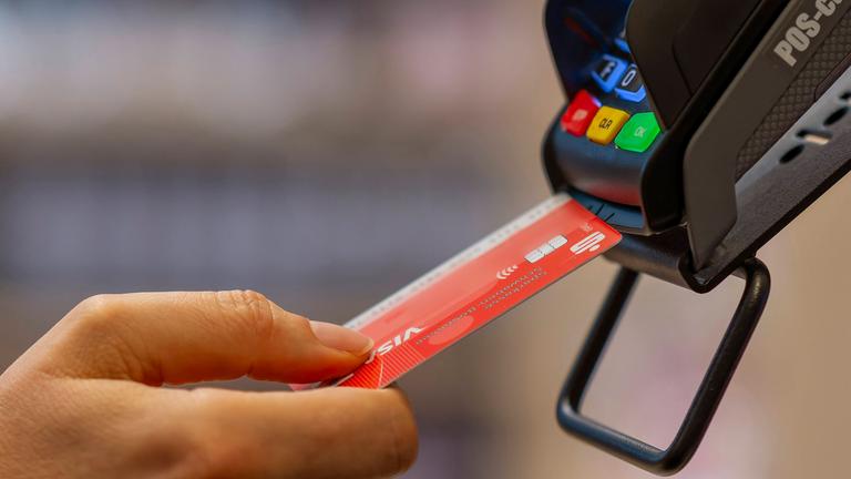 Frau bezahlt mit der EC-Karte im Geschäft