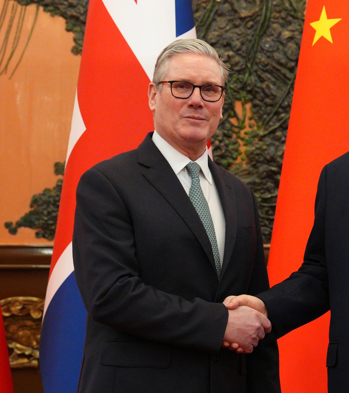 Premierminister Sir Keir Starmer schüttelt Präsident Xi Jinping vor einem bilateralen Treffen in der Großen Halle des Volkes in Peking die Hand. 