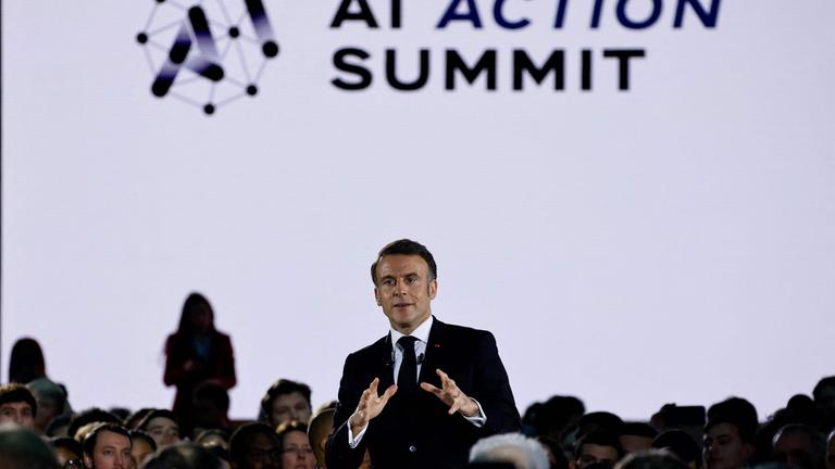 France's President Emmanuel Macron (C) delivers a speech during a closing event for the first day of the Artificial Intelligence (AI) Action Summit, at the Grand Palais, in Paris