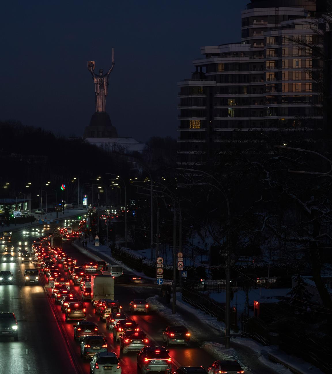 Cars drive along a road during a power outage in downtown Kyiv, Ukraine, 20 January 2026