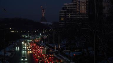 Cars drive along a road during a power outage in downtown Kyiv, Ukraine, 20 January 2026