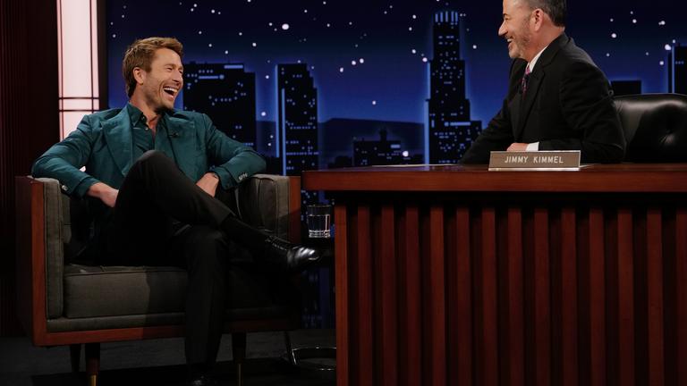 This image released by Disney shows guest Glen Powell, left, and host Jimmy Kimmel on "Jimmy Kimmel Live!" in Los Angeles