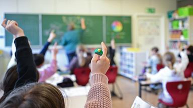 Schüler melden sich in einer vierten Klasse in einer Grundschule in Stuttgart