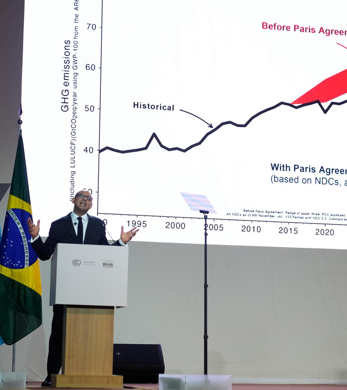 Simon Stiell, United Nations climate chief, speaks during a plenary session in front of a graphic on the Paris Agreement at the COP30 U.N. Climate Summit