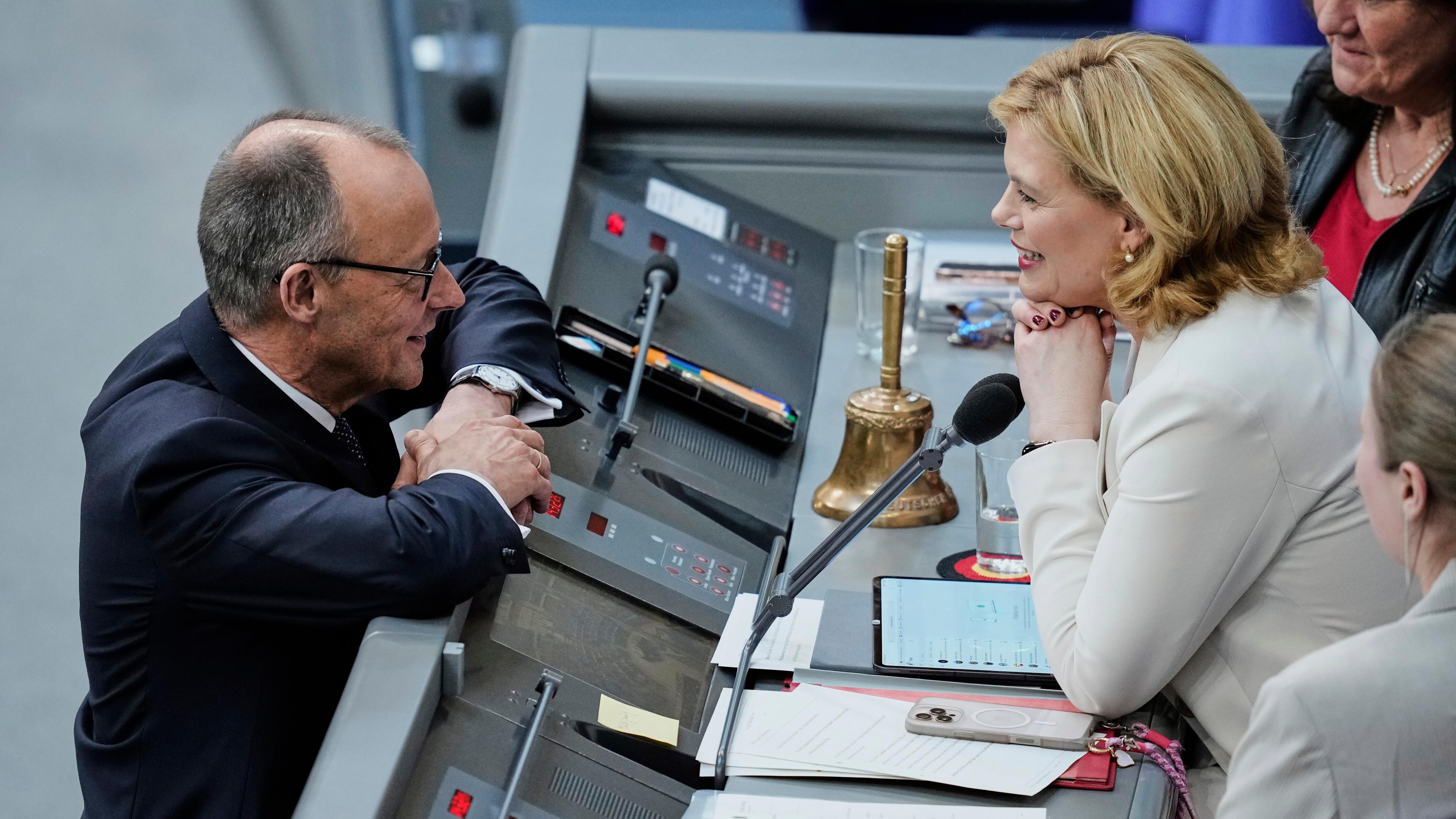 Julia Kloeckner, right, talks to CDU leader Friedrich Metz after being elected new Parliament President during the constituent session of the newly elected German Parliament Bundestag in Berlin