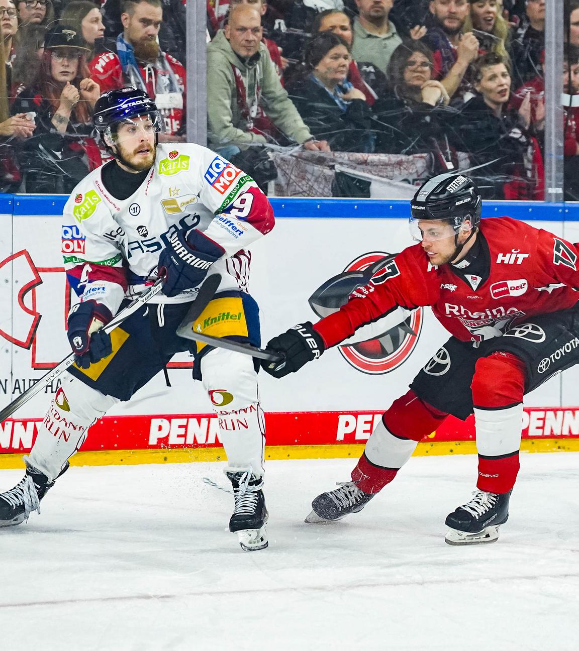 Der Berliner Ty Ronning und Jan Luca Sennhenn von den Kölner Haien im Kampf um den Puck