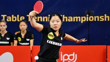 Koharu Itagaki spielt bei einem Tischtennis-Wettkampf einen Rückhandschlag mit einem roten Schläger.