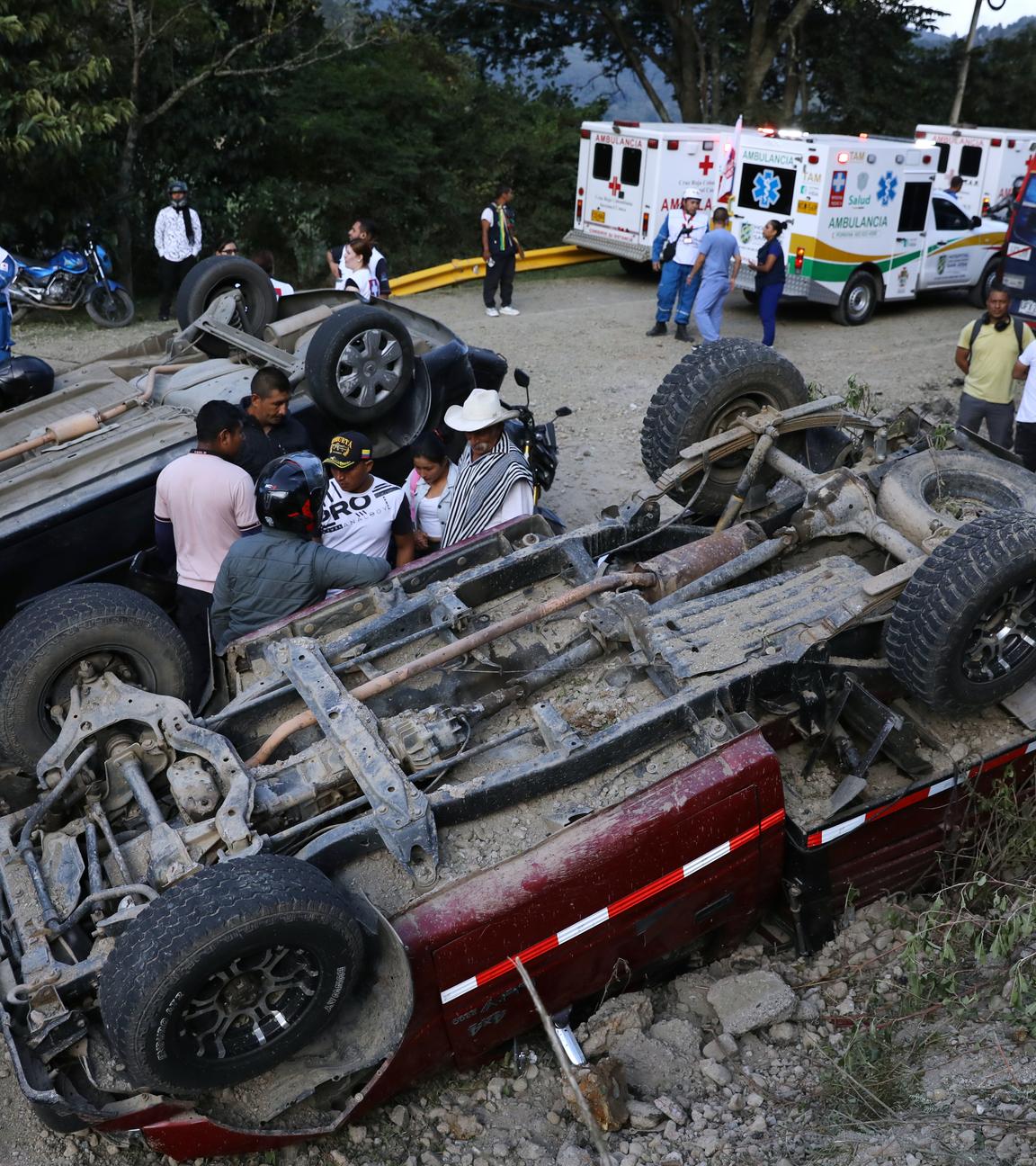 Menschen stehen zwischen Fahrzeugen, die bei einem Angriff auf dem Panamericana-Highway in Cajibio, Kolumbien, am Samstag, dem 25. April 2026, beschädigt wurden.