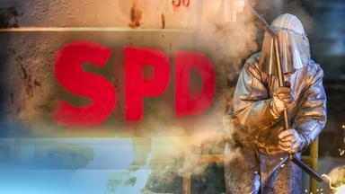 Das Logo der SPD neben einem Fabrikarbeiter